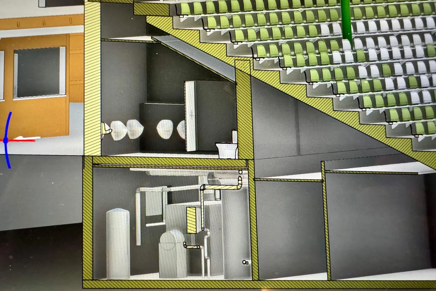 Coupe de la maquette BIM montrant les sièges, les sanitaires et les canalisations sous la tribune
